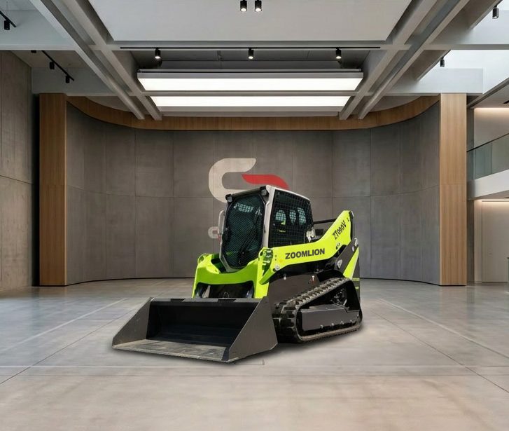 Chargeuses compactes - C Distribution - Concessionnaire Zoomlion Rhône Alpes Chargeuse compacte verte et noir sur une surface en béton, avec un ciel clair en arrière-plan.